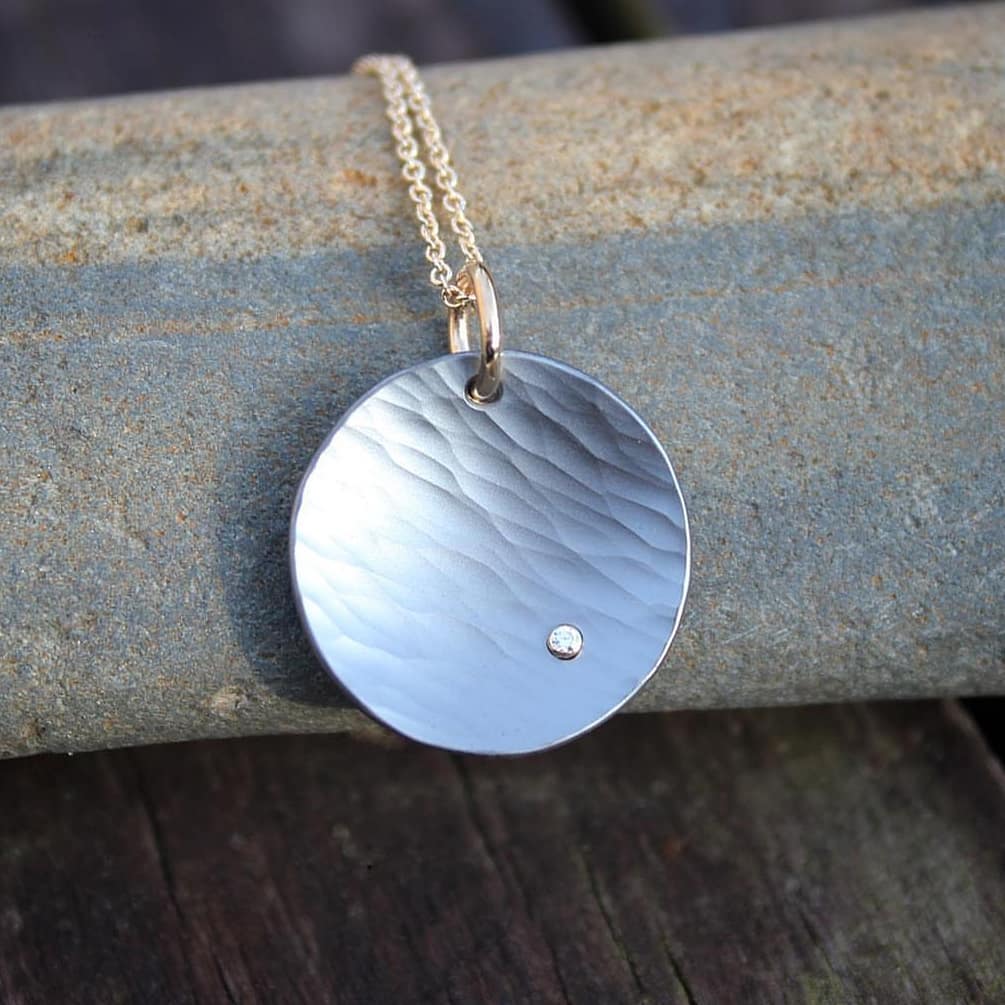 silver and gold pendant